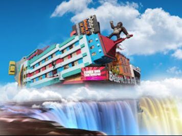 Fake gorilla on top of a Ripley's building overlooking a painted Niagara Falls in Ontario